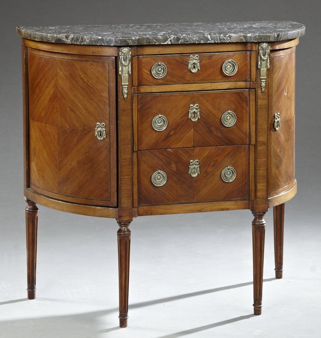 Diminutive French Louis XVI Style Ormolu Mounted: Diminutive French Louis XVI Style Ormolu Mounted Mahogany Marble Top Commode, 19th c., the highly figured breakfront black marble over a central bank of three drawers, flanked by two concave inlaid cu