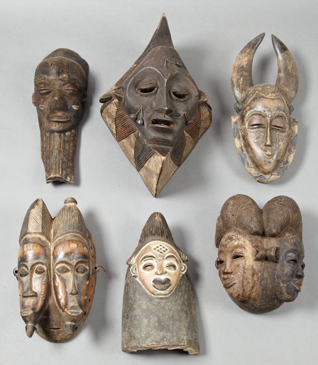 Group of Six African Carved Wood Masks, 20th c., one: Group of Six African Carved Wood Masks, 20th c., one with horns, two with two faces, one with a beard, one polychromed example, and a large polychromed example with hair and a beard and cheek ornament