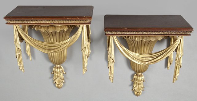 Pair of Neo-Classical Gilt Composition and Wood Wall: Pair of Neo-Classical Gilt Composition and Wood Wall Brackets, 20th c., the mahogany shelves with pendant drapery garland, on a reeded tapered urn back plate, H.- 19 1/2 in., W.- 16 5/8 in., D.- 10 in