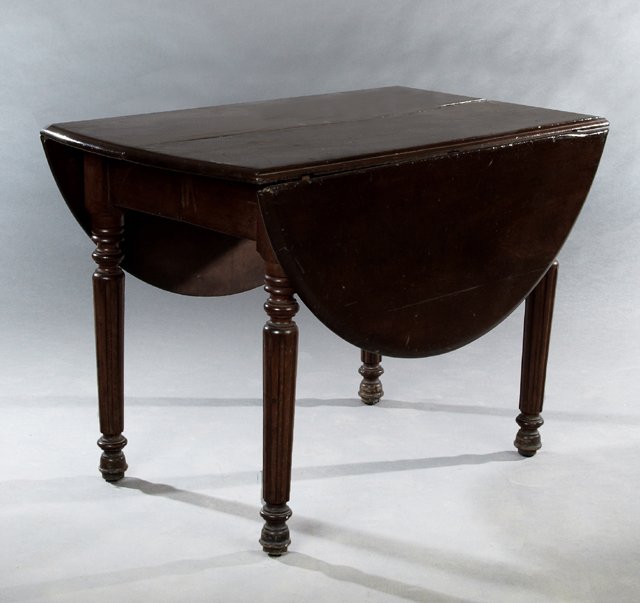 American Carved Walnut Drop Leaf Dining Table, 19th c.,: American Carved Walnut Drop Leaf Dining Table, 19th c., the oval top over a wide skirt on ring turned tapered fluted legs to ball feet, now lacking leaves, Closed- H.- 28 in., W.- 41 in., D.- 23 1/2 i