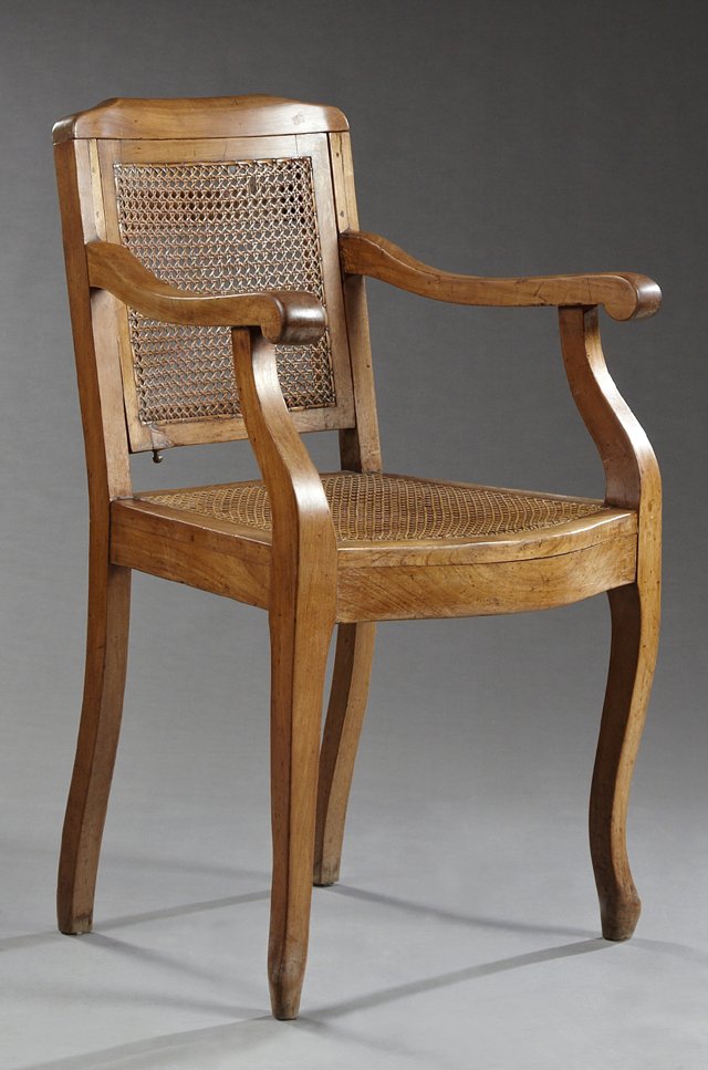 French Directoire Carved Cherry Caned Adjustable: French Directoire Carved Cherry Caned Adjustable Fauteuil, 19th c., the arched crest rail to a square back adjusting to the sitter's height, over a bowed seat within two carved scrolled arms on cabrio