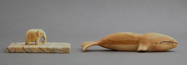 Inuit Carved Ivory Tupilak of a Whale, together with a: Inuit Carved Ivory Tupilak of a Whale, together with a carved ivory elephant on an agate base, Whale- H.- 1 1/4 in., W.- 5 3/4 in., D.- 1 3/4 in.