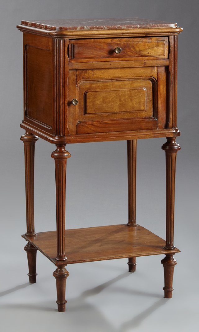 French Louis XVI Style Carved Walnut Marble Top: French Louis XVI Style Carved Walnut Marble Top Nightstand, c. 1900, the inset highly figured rouge marble above a frieze drawer over a cupboard door opening to a porcelain lined interior flanked by c