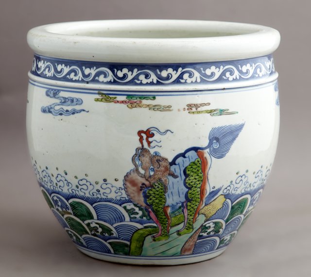 Chinese Porcelain Baluster Jardiniere, 20th c., with: Chinese Porcelain Baluster Jardiniere, 20th c., with decorations of fanciful Foo dogs in the waves, signed on the underside, H.- 9 in., Dia.- 10 1/2 in.