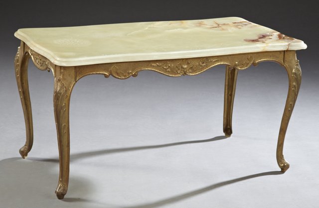 French Louis XVI Style Gilt Bronze and Onyx Marble Top: French Louis XVI Style Gilt Bronze and Onyx Marble Top Coffee Table, c. 1940, the figured onyx top over a relief serpentine skirt, on cabriole legs with relief pad feet, H.- 17 1/4 in., W.- 33 1/2 in.