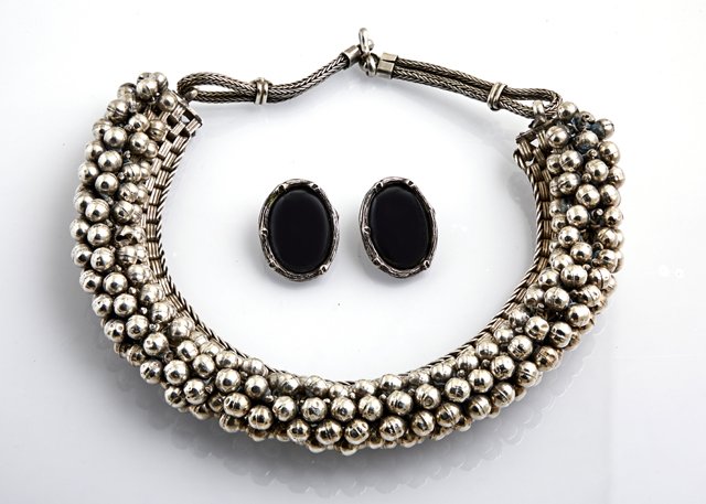 Three Pieces of Jewelry, consisting of a pair of Mignon: Three Pieces of Jewelry, consisting of a pair of Mignon Faget (New Orleans) sterling and hematite clip earrings and an Indian silverplated flexible link choker with relief floral links, and five conce