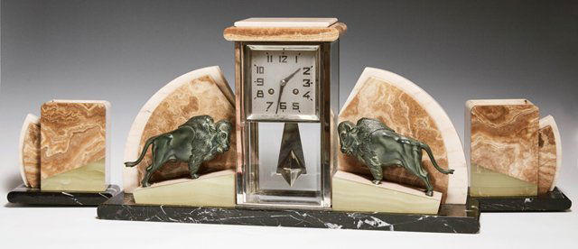 French Three Piece Art Deco Marble, Alabaster and Onyx: French Three Piece Art Deco Marble, Alabaster and Onyx Clock Set, c. 1940, with a central geometric rectangular beveled glass chrome mounted time and strike clock, flanked by inclined onyx and creme m