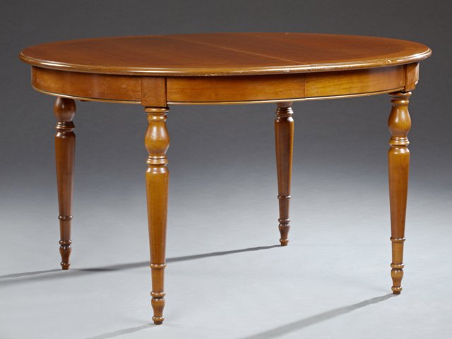 French Louis Philippe Style Carved Cherry Dining Table,: French Louis Philippe Style Carved Cherry Dining Table, 20th c., the oval top over a wide skirt on ring turned tapered legs with ball feet, with one leaf, Open- H.- 29 1/4 in., W.- 65 3/4 in., D.- 43