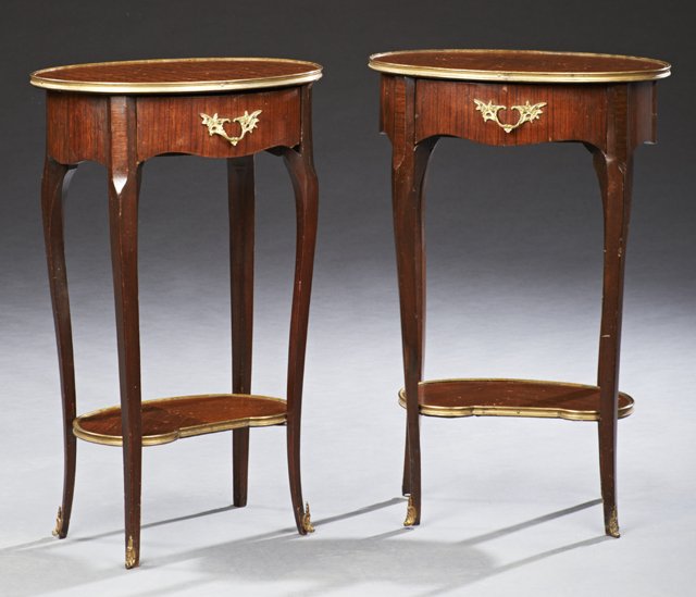 Pair of French Brass Mounted Carved Mahogany: Pair of French Brass Mounted Carved Mahogany Nightstands, early 20th c., the brass bound oval parquetry top over a frieze drawer, on tapered cabriole legs with ormolu sabots, joined by a lower brass b