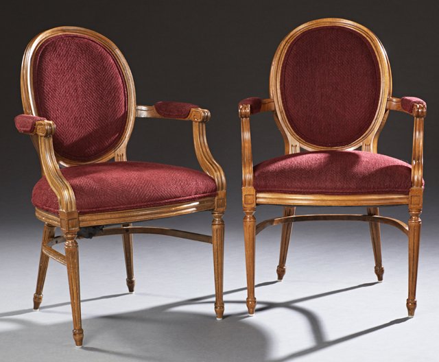 Pair of Carved Beech Louis XVI Style Fauteuils, 20th: Pair of Carved Beech Louis XVI Style Fauteuils, 20th c., the oval medallion backs over upholstered arms and bowed seats, on tapered reeded legs with toupie feet, H.- 38 1/2 in., W.- 23 1/2 in., D.- 23