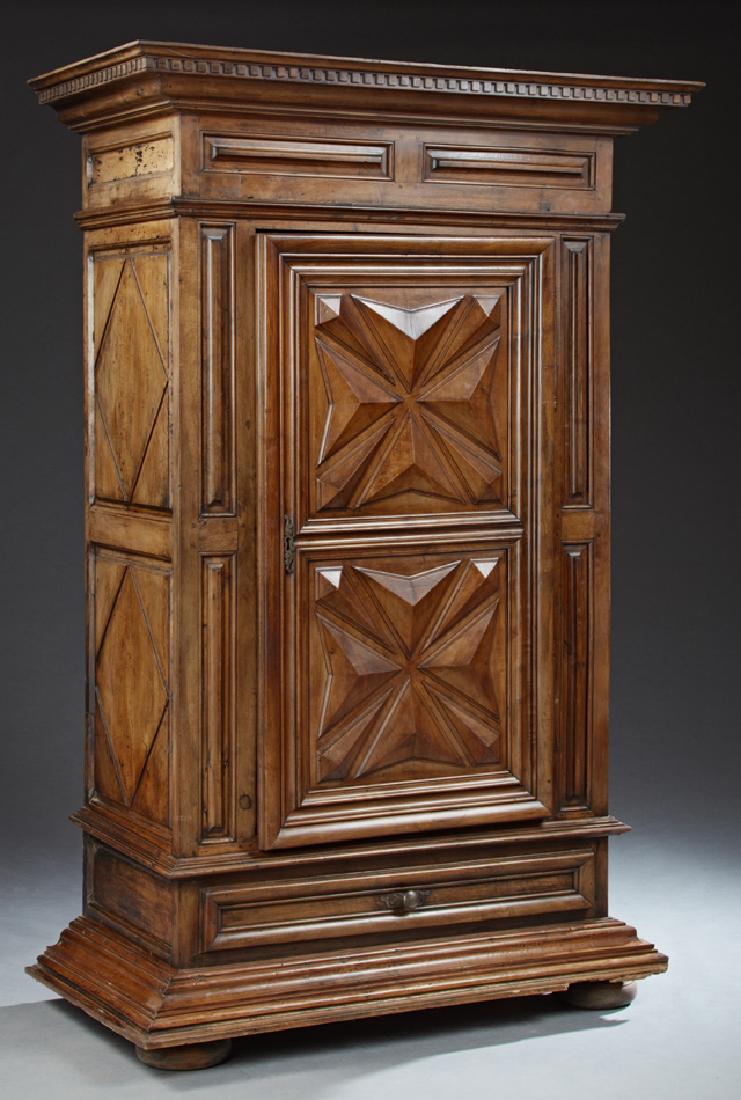 French Louis XIII Style Carved Walnut Armoire, 19th c.,: French Louis XIII Style Carved Walnut Armoire, 19th c., the dentillated stepped crown above a geometric carved door with a short iron escutcheon and short iron butt hinges, flanked by carved stiles an