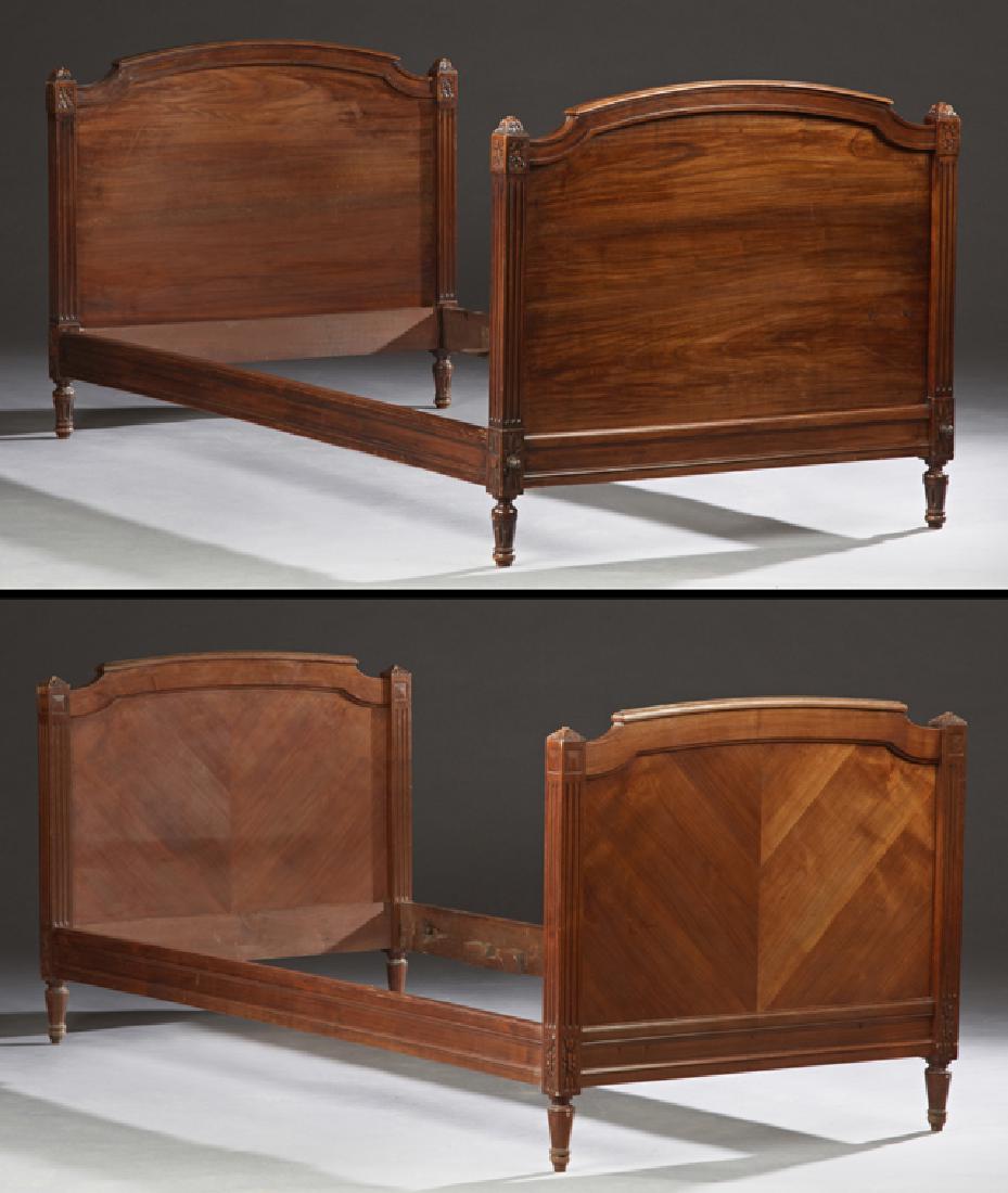 Pair of Louis XVI Style Carved Walnut Daybeds, late: Pair of Louis XVI Style Carved Walnut Daybeds, late 19th c., with arched walnut head and foot boards, bordered by reeded pilasters, H.- 34 in., Int. W.- 36 in., Int. D.- in.