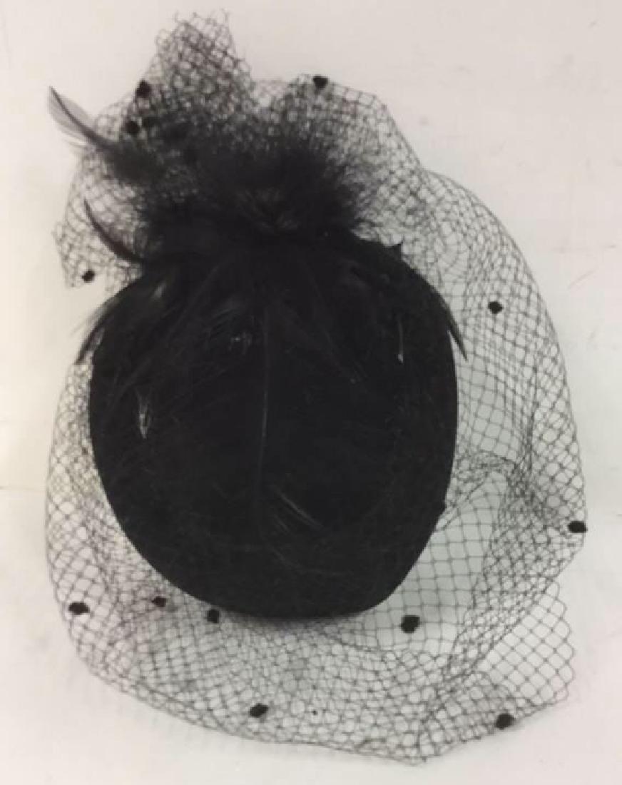 Vintage Ladies Feather With Netting Hat Vintage Ladies: NY. Black hat has black netting with mini Pom poms around entire hat that covers the eyes. Feathers lay across top of hat. Inside Circumstances measures" 7". Comes with original hat box.. Property Of 