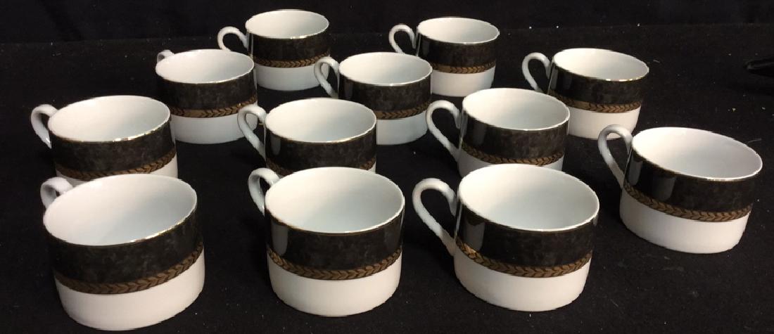 Set !2 Of Retroneu China Coffee Cups: One dozen coffee cups from the Retroneu Fine China Imperial Collection Grey.marked on underside pattern. White, black gold band and trim. Measures 3.25 inches in diameter without handle. Comes with ca