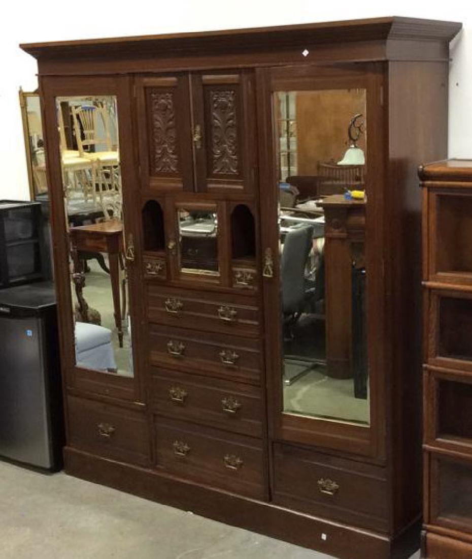3 Piece Mirrored and Carved Antique Armoire Carved: Carved Armoire comes in three pieces, single crown molding along top over center carved cabinets, cubbies, and 6 drawers. Brass hardware. Panels in French Style of urns vines and flowers.each side clo