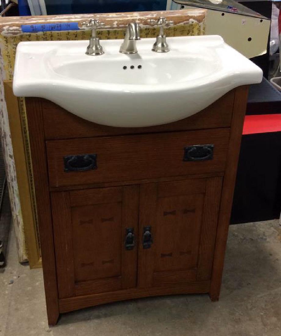 Porcelain sink  with fixtures set in Vanity Cabinet (1 of 7)