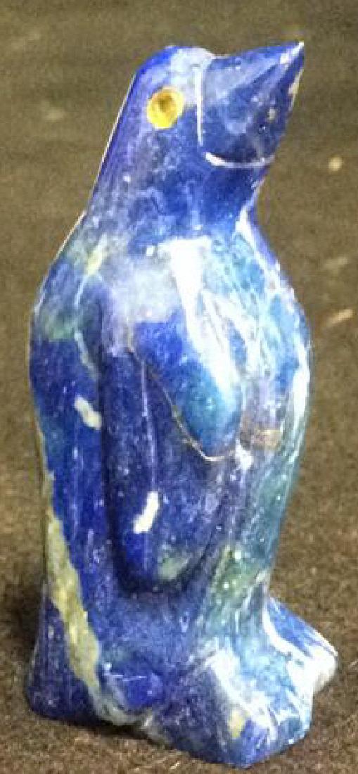 Group Lot Penguin Figurines Glass Stone Wood Metal: Group Lot 18 Penguin Figurines 2 carved wood, musical snow globe, 1 blue stone, possibly lapis and more. Tallest measures approx 7 1/2 inches. Property of Manhattan estate. Penguin Figurine Collectibl