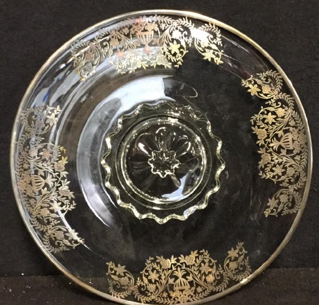 Vintage silver on Glass Cake Plate: Cake plate of glass with silver metal rim and silver /iridescent floral embossed design around perimeter of plate. Shallow 1 inch stand. Plate measures 13.5 inches in diameter.