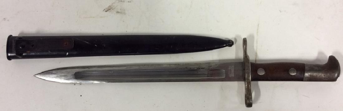 Swiss Waffenfabrik Neuhausen Bayonet and Sheath: Swiss Army Bayonet and sheath marked for Waffenfabrik Neuhausen, serial number on cross guard, military artifact likely from WWI. Comes with metal sheath. Blade measures approx 11 7/8 inches. Unsheath