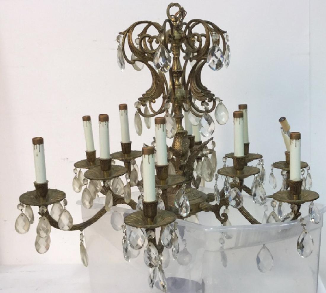 Art Nouveau 12 Arm Gilded Iron Crystal Chandelier: Gilded iron, Crystal Candelabra style Chandelier, hanging light fixture with 12 arms; crystal scroll design canopy over second urn form canopy with feather form arms; all supporting 2-piece crystal pr