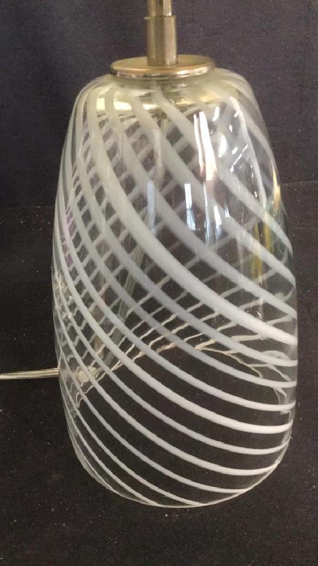 Art Glass Table Lamp: Art Glass Table Lamp with shade; features clear glass with white opaque diagonal swirl stripes. Measures approx 21 inches tall including shade on an approx 6 1/4 inch diameter base. Lamp Lighting Tabl