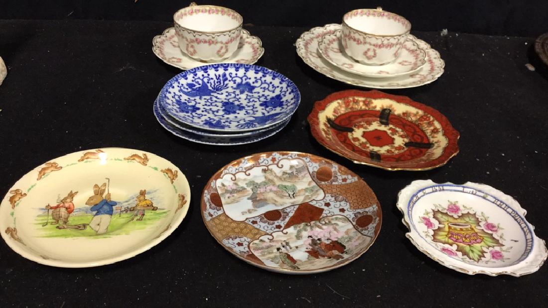 Group Lot Vintage Assorted China: 12 pieces of assorted china: 5 pieces of Theodore Haviland Limoges France (dessert plate, 2 cups and 2 saucers), 3 unmarked blue and white saucers marked made in Japan; 1 Asian pattern saucer with Chi