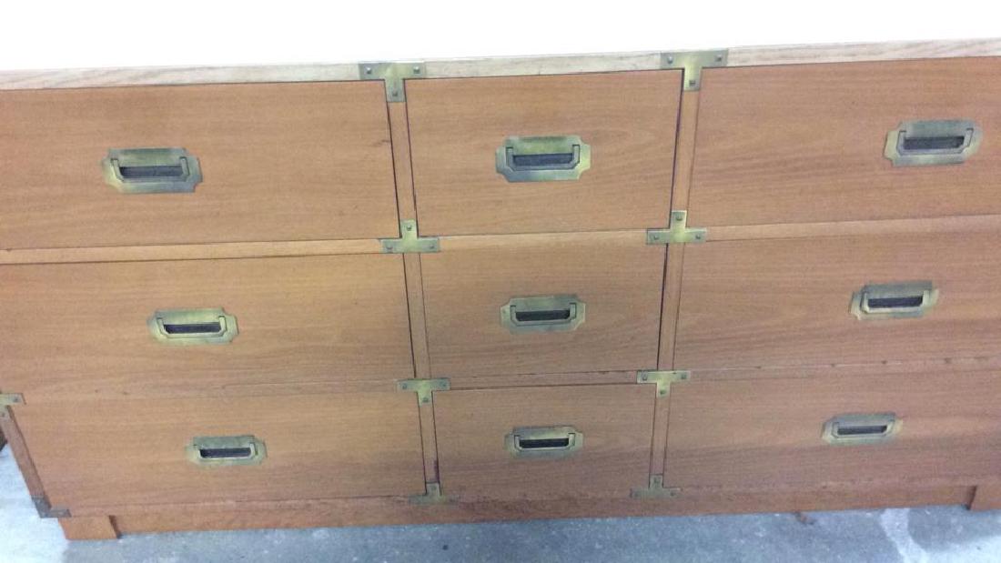 9 Drawer Campaign Style Dresser: Flush brass mount drawer pulls, brass corners. Wood frame and drawers with added Formica top. Measures ht 31 inches length 58 inches depth 19 inches. Property of multi generationPound Ridge New York E