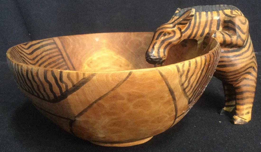 Carved Wooden Sculpture Zebra Drinking from Bowl: Hand carved, Hand painted, carved wooden zebra figurine drinking from wooden bowl. Bowl Measures approx 9 inches diameter and is approx 4 inches tall. Entire piece including zebra measures approx 10 i