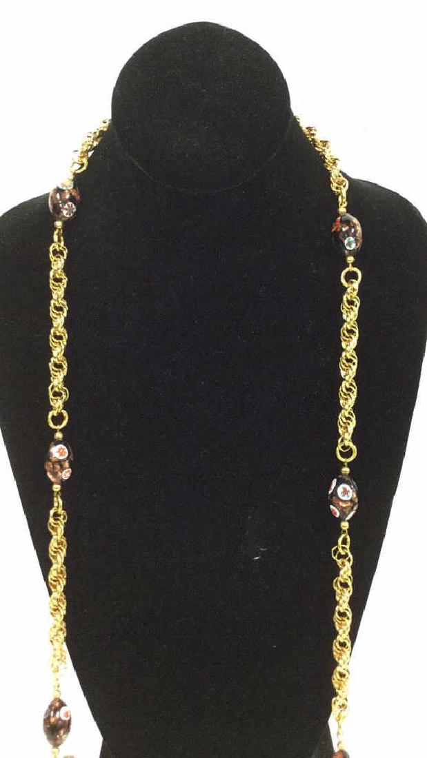 Vintage Bead Chain Opera Length Lariat: Gold tone chain links and tassels, millefiori style floral beads. Measures approx 50 inches. 1960's, 70's and 80's jewelry designer, importer and whole seller with Neiman Marcus, Bloomingdales and Lor