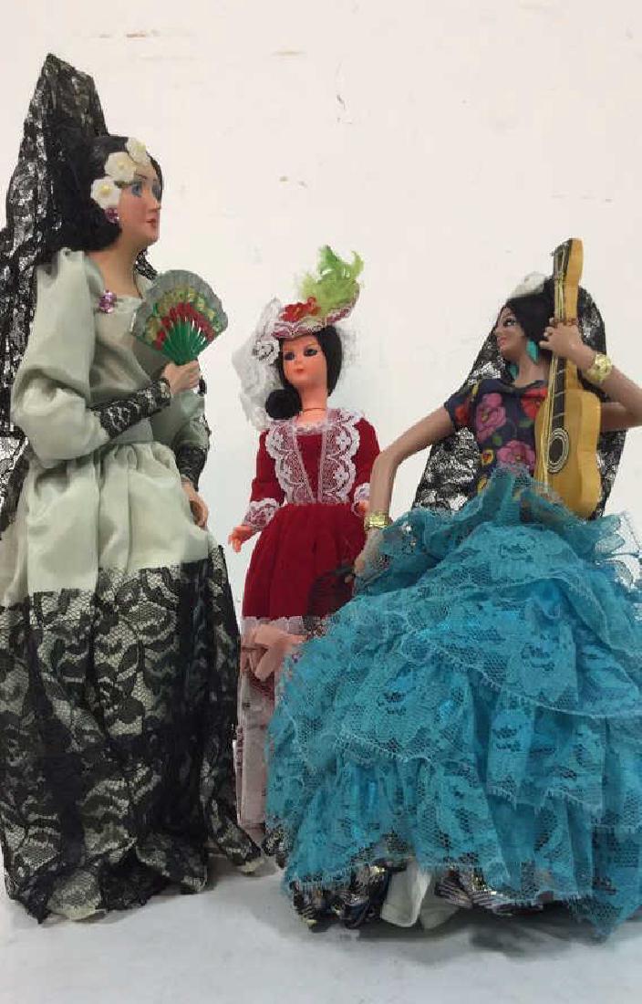 Lot of 3 Collectible Spanish Style Dolls: Composite doll with handheld fan measures approx 13 inches high 6 inches wide.