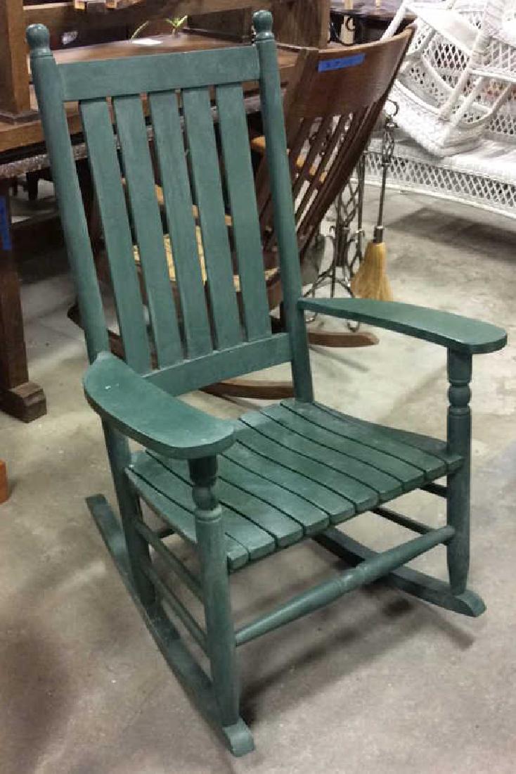 Painted Green Outdoor Rocking Chair: Outdoor wood rocking chair in Shaker Style, Adirondack Style, painted green slat back and seat. Wide flared armrests. Good Condition. Measures ht 41 inches, width 28 inches depth 36 inches