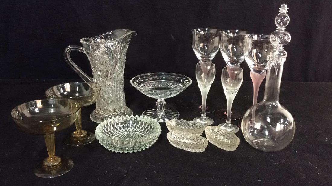 Group Cut Crystal Hand Blown Glass Table Articles: Group lot cut glass pitcher vintage measures app 9 inches ht, footed candy dish cut glass, 3 stemmed wine glasses, 2 stemmed cordial contemporary hand blown flask with tall stopper, 3 salt cellars, ro