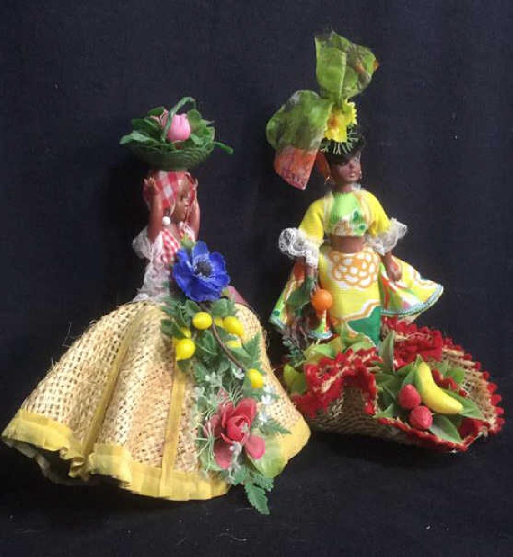 2 Caribbean Dolls in Traditional Dress: bodies made from plastic, taller doll measures 13 inches tall and marked for Chiquita Doll from Bermuda and Caribbean Market.