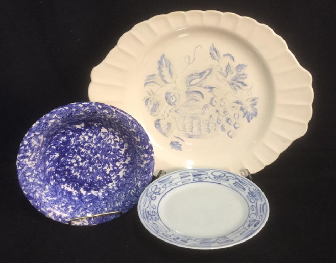 Lot 3 Blue on White Collectible Dishware Decor: Includes handled platter marked for Limoges which measures approx 15 inches long by 12 inches wide; spongeware bowl marked for Italy and Asian design plate.
