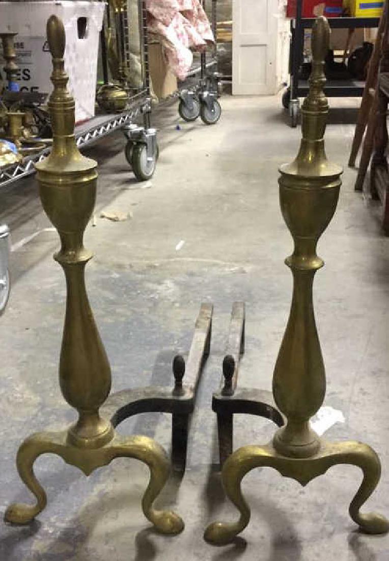 Pair Of Vintage Andirons: Possibly brass, each measures approx 20 inches H x 7.5 inches Wx 18 inches D. Property of a Scarsdale estate.