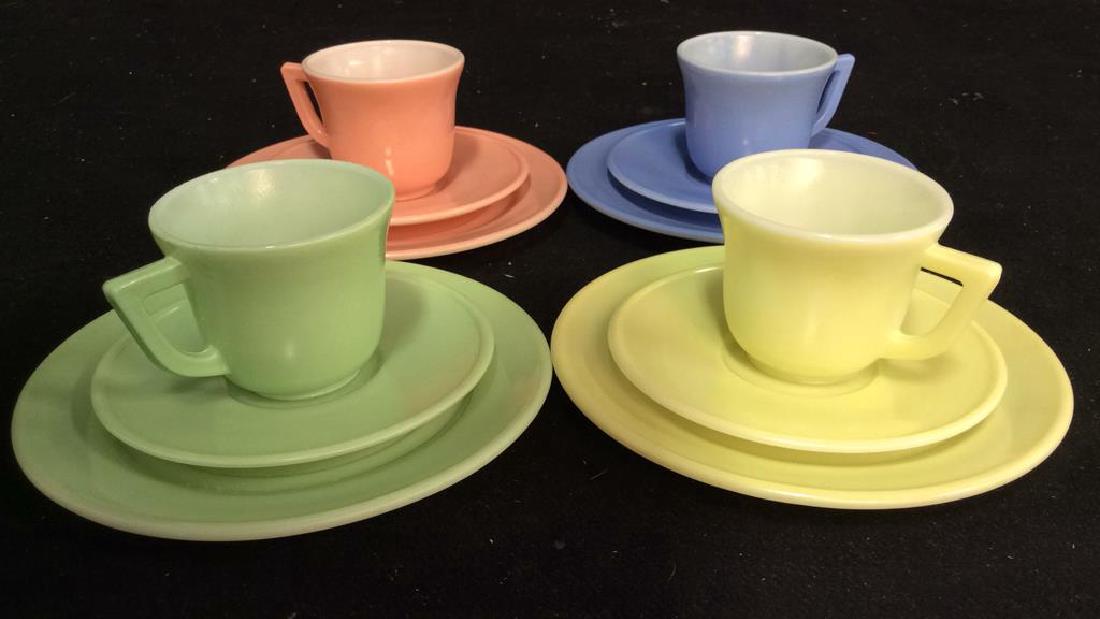 Lot of 12 Pastel Toned Glass Tea Set: Pastel tones include periwinkle, salmon, mint and lemon chiffon. Includes 4 teacups, 4 butter pats and 4 bread plates. Bread plate measures approx 6 inches diameter. Teacups measure approx 2 inches ta