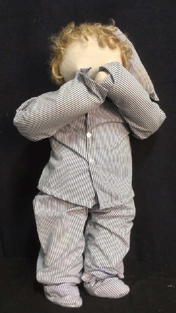 Fabric Doll Stuffed Boy in Striped Pajamas: Hands are attached to face. Small brown stain on shirt. Measures approx 14 inches wide and 25 inches tall.