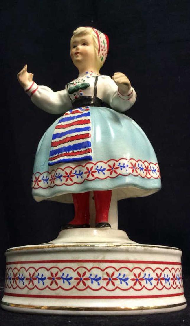 SCHMID BROS Bavarian Girl Porcelain Figurine: Vintage SCHMID BROS Revolving musical figurine. Some crazing present. Minor chips. Otherwise no other condition issues noted.