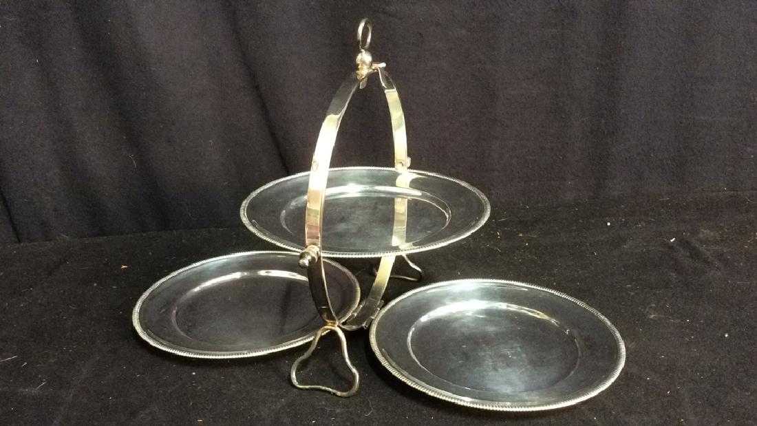 Vintage Silver Tone Tiered Dessert Plate Stand: Marked for Italy, marked for de Wertl, vintage, silver tone, possibly silver plate, tiered dessert plate stand. Measures approx 16.5 inches wide and 10 inches long.