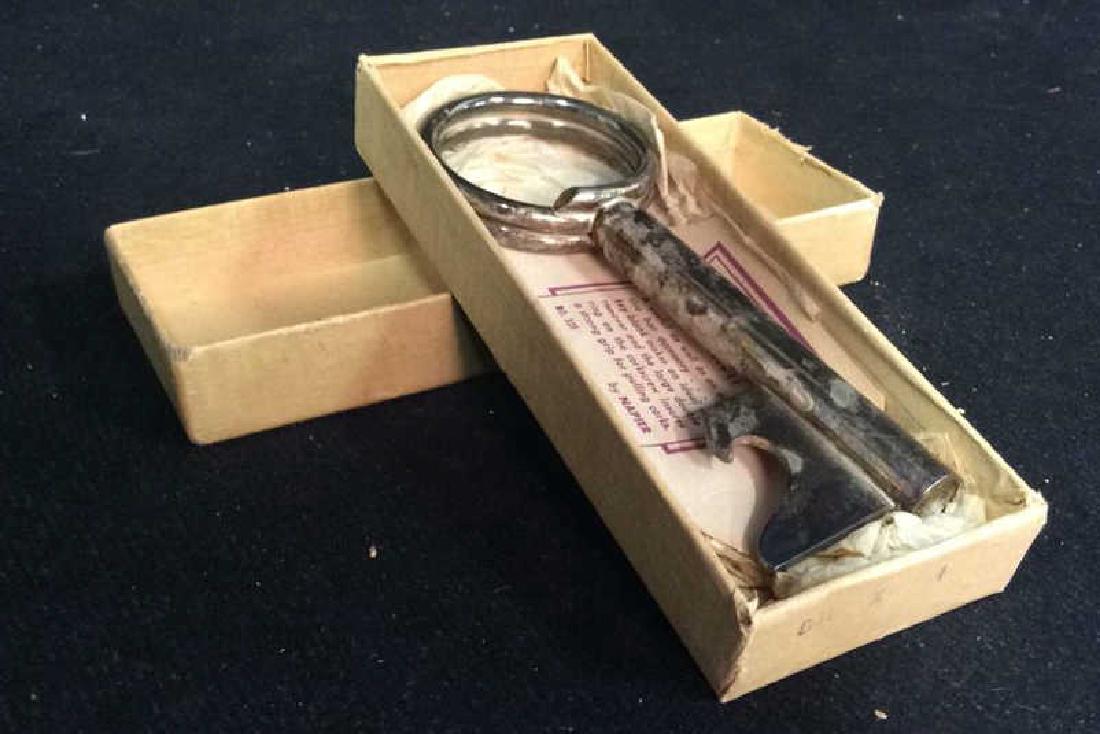 Silver Plated KEY TO THE SOLUTION by NAPIER: inside paper reads A useful as well as an attractive bar accessory... The key blank makes an ideal cap remover and the large double ring on the corkscrew insures a strong grip for pulling corks. No. 1