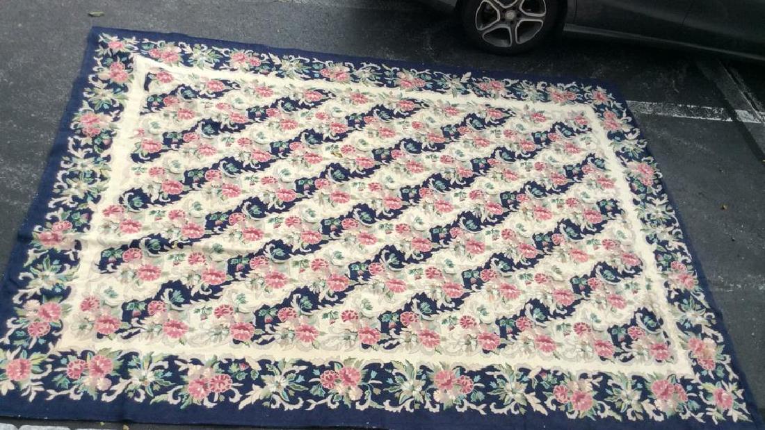 BILL BLASS Hand Woven Wool Rug: Marking reads GENUINE HAND WOVEN RUG BILL BLASS FOR SPRINGMAID. Contains floral pattern detail wth tones of magenta, navy, cream, and green. Measures approx 102 inches wide 138 inches long. Property o