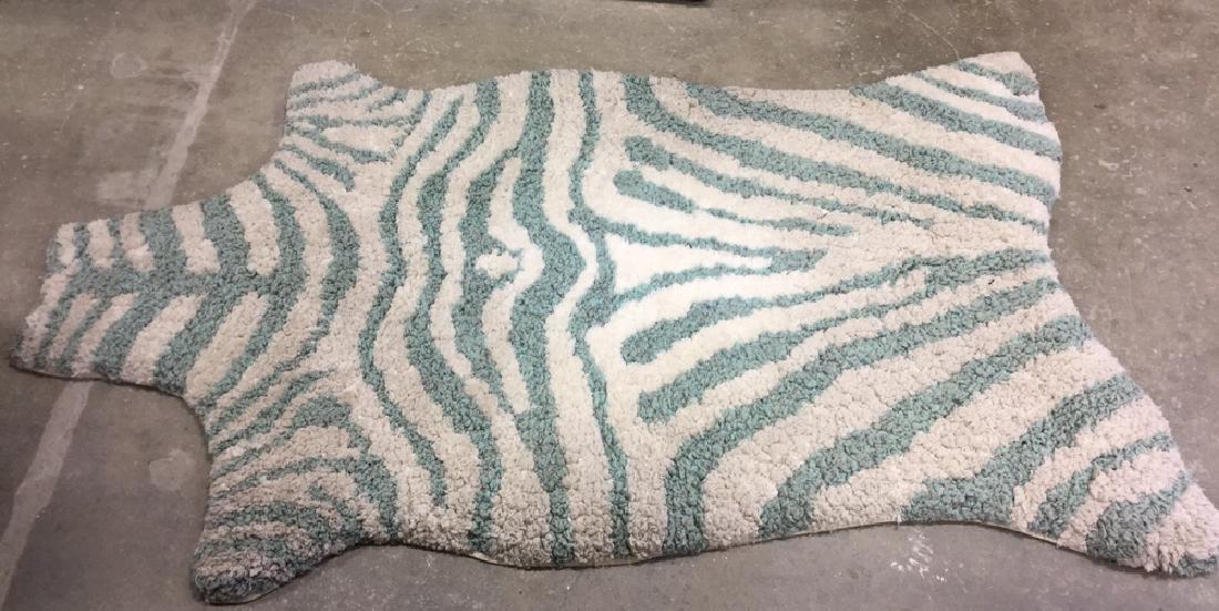 ZULU Shag Zebra Rug: Hand tufted shag rug from Country Willow, ZULU collection, zebra pattern in aqua and white, polyester made in India. Measures approx 3.5 ft x 5.5 ft. Needs cleaning, otherwise good condition.