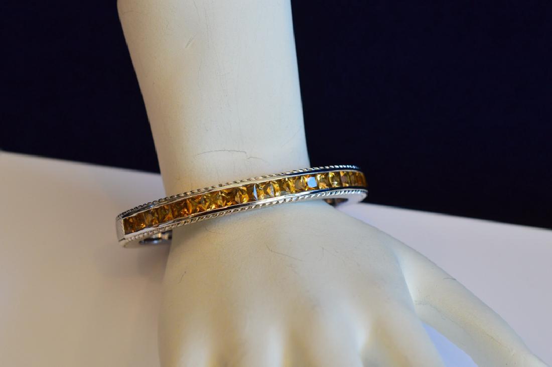 Judith Ripka 7 "Sterling & Citrine Hinged Cuff: 7" Sterling silver cuff with hinge and decorated with yellow citrine stones. Measures 1/4" wide. Designer Jewelry