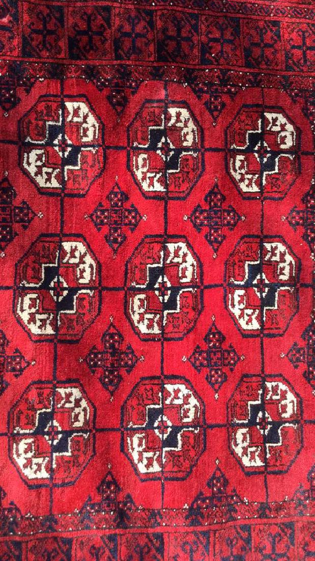 Ruby Toned Oriental Fringed Carpet: Vintage Carpet, Rug, Oriental Carpet, Contains tones of ruby, navy, and cream. Fringed edges. Intricate geometric detail. Measures approx 120 inches long by 84 inches wide. Property of Chappaqua estat