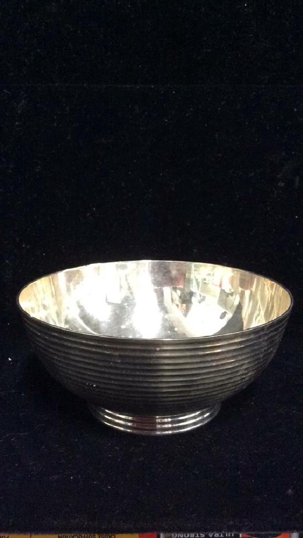 Silver Toned Metal Bowl: Silver Toned Metal Bowl. Silver toned tableware measures approx 2 1/2 in tall by 5 1/2 in wide,