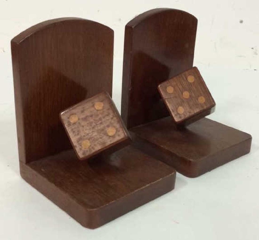 Pair Carved Wooden Rolling Dice Bookends: Lot 2 Wooden Rolling Dice Bookends Pair, Set bookends, Dice theme,. Carved wooden bookends with three dimensional rolling dice. Measures approx 6 in tall by 4 1/4 in wide by 5 in long. Property of Gre