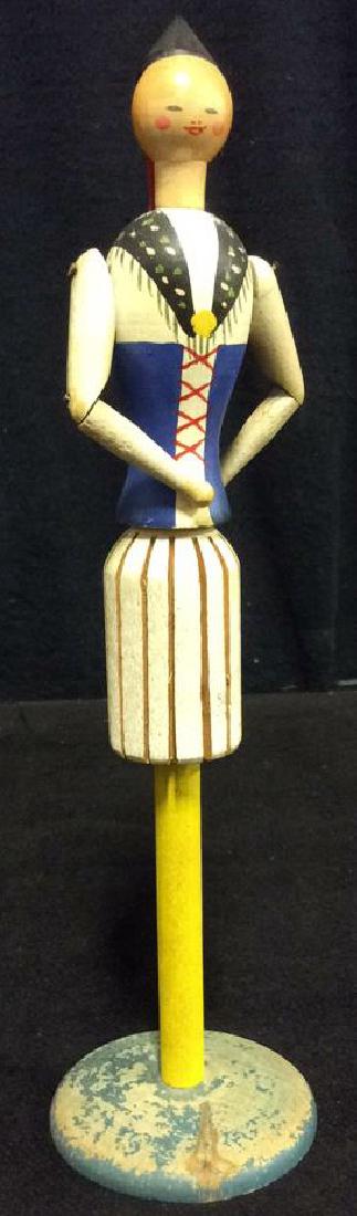 Vintage Folk Art Doll Figurine: Vintage Painted Wood Doll Figurine. Vintage jointed wooden doll figurine in medieval esque fashion. Measures approx 11 in tall by 3 in in diameter. Marked illegibly on bottom. Folk Art, Property of Ka