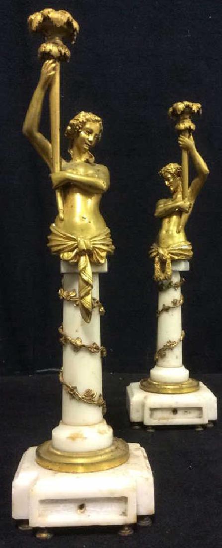 Antique Pr Gilded Metal Marble Figure Candlesticks: Antique Pair, Gilded Metal, Ormolu, Stylized figurals on columnar marble bases, 2 Nude Gold Toned Figure Candlestick Holders with marble base and gold toned feet. Nude torso figurines are holding torc