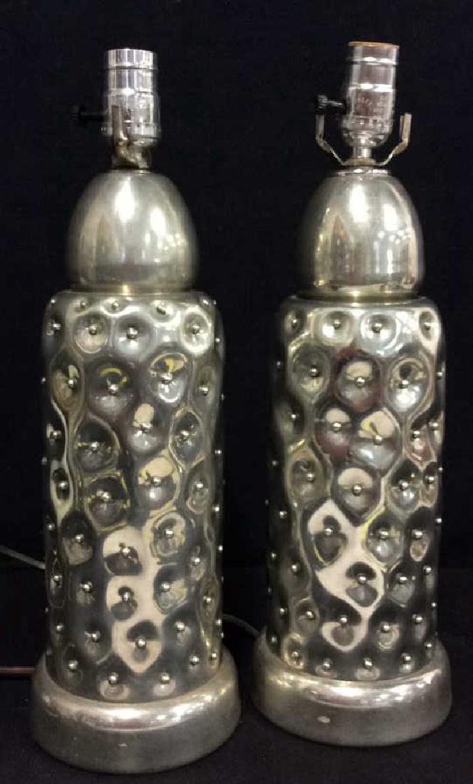 Signed Silver Toned Metal Lamps: Signed Silver Toned Metal Lamps. Pair of silver toned metal lamps with dimensional depressed detail with small metal beading. Signed illegibly, marked as c1992. Measures approx 17 in tall by 6 in in d