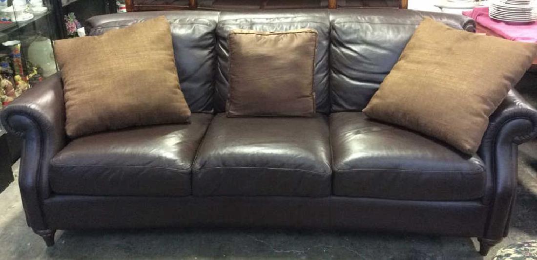 NATUZZI Leather Couch Sofa W Pillows: NATUZZI Brown Toned Leather Couch W 3 throw Pillows. Couch, Sofa, Carved wooden feet. Marked NATUZZI on one of wooden feet. minor blemish on armrest. Good Condition. Measures approx 90 inches long 40